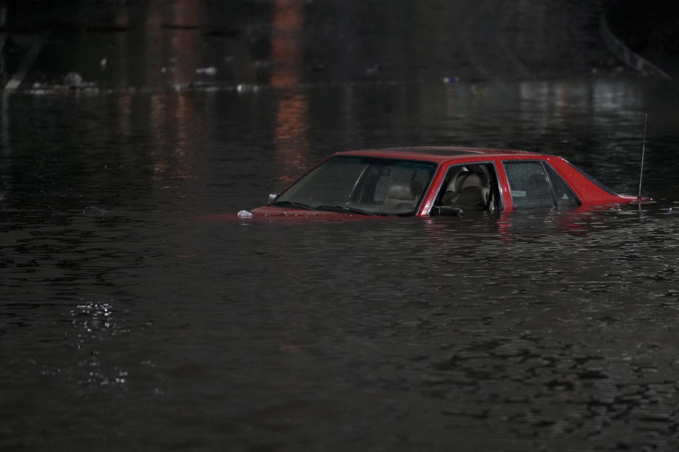 FILE - An empty vehicle is surrounded by floodwaters on a road in Oakland, Calif., Jan. 4, 2023. A new study says the drenching that California has been getting since Christmas will only get wetter and nastier with climate change. (AP Photo/Godofredo A. Vásquez, File)