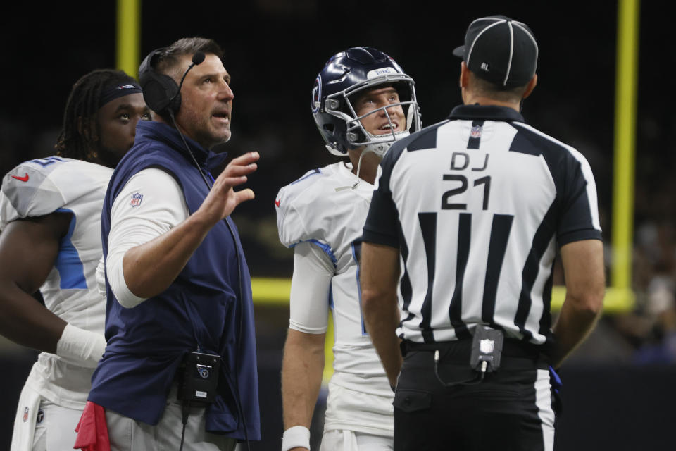 Tennessee Titans head coach Mike Vrabel, left, and quarterback Ryan Tannehill, center, talk to a referee in the first half of an NFL football game against the New Orleans Saints in New Orleans, Sunday, Sept. 10, 2023. (AP Photo/Butch Dill)