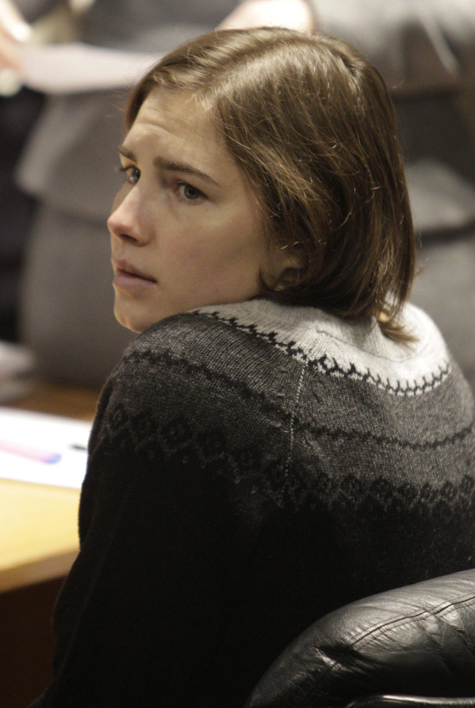 File-This Dec. 11, 2010, file photo shows Amanda Knox sitting at the beginning of a hearing in her appeals trial, at Perugia's courthouse, Italy. To many Americans, especially in her hometown of Seattle, Amanda Knox seems the victim, unfairly hounded by a capricious foreign legal system for the death of a 21-year-old British woman. But in Italy and elsewhere in Europe, others see her as someone who got away with murder, embroiled in a case that continues to make global headlines and reinforces a negative image of Americans behaving badly, even criminally, abroad without any punishment. As she remains free in the U.S., these perceptions will not only fuel the debate about who killed Meredith Kercher in 2007 and what role, if any, Knox played in her death, but also about whether U.S. authorities should, if asked, send her to Italy to face prison. (AP Photo/Pier Paolo Cito, File)