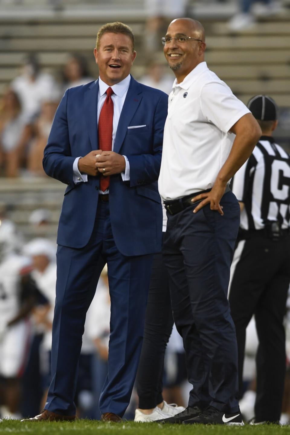 Penn State coach James Franklin watches warm ups with ESPN analyst Kirk Herbstreit