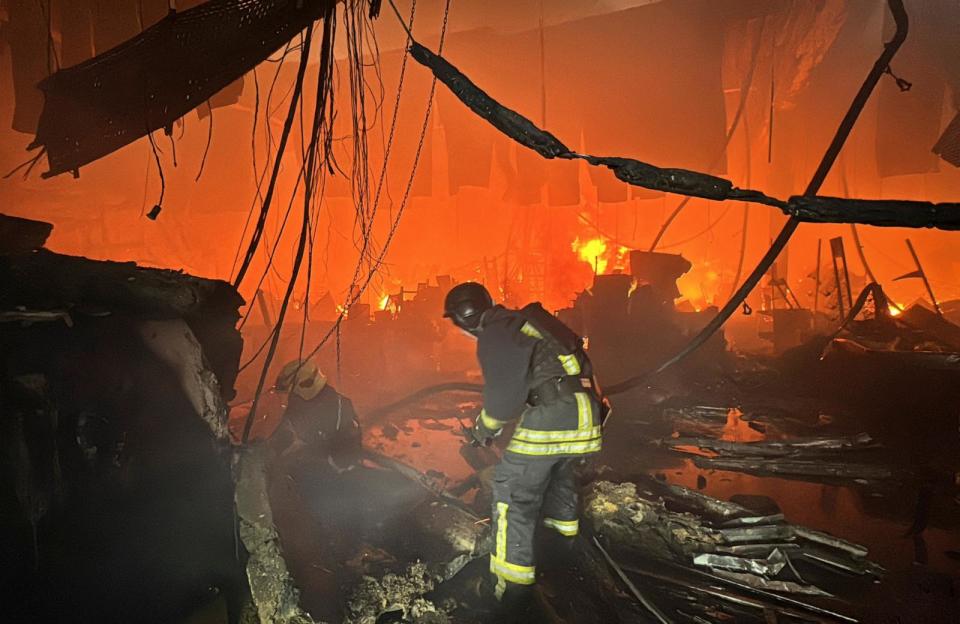 PHOTO: Firefighters work at a site of a household item shopping mall hit by a Russian air strike, amid Russia's attack on Ukraine, in Kharkiv, Ukraine, on May 25, 2024.  (Vitalii Hnidyi/Reuters)