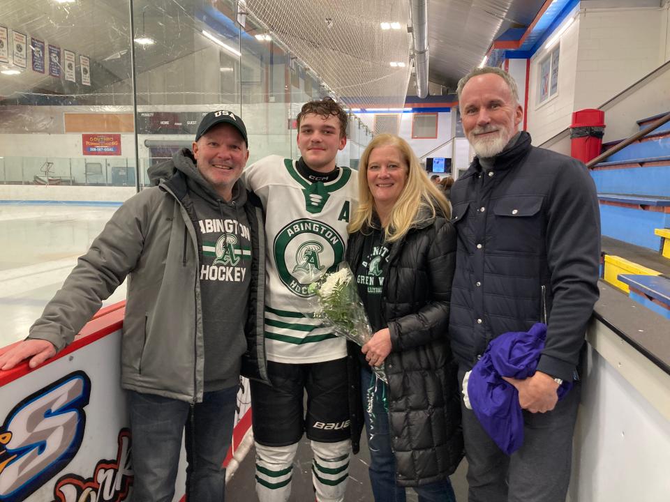 ESPN's John Buccigross, of Plymouth, far right, poses for a postgame photo at Rockland Ice Rink on Monday, Feb. 12, 2024. Abington High senior defenseman Zach Buccigross is pictured, along with Zach's dad, Eddie (a cousin of John Buccigross), and Zach's mom, Jen.