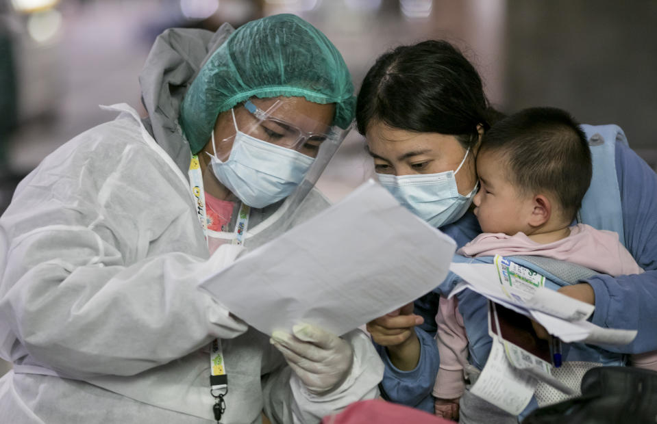 A public health worker gather information from Chinese tourists from Shanghai who arrived at Suvarnabhumi airport on a "Special Tourist Visa, in Bangkok, Thailand, Tuesday, Oct 20, 2020. Thailand on Tuesday took a modest step toward reviving its coronavirus-battered tourist industry by welcoming 39 visitors who flew in from Shanghai, the first such arrival since normal traveler arrivals were banned almost seven months ago. (AP Photo/ Wason Wanichakorn)