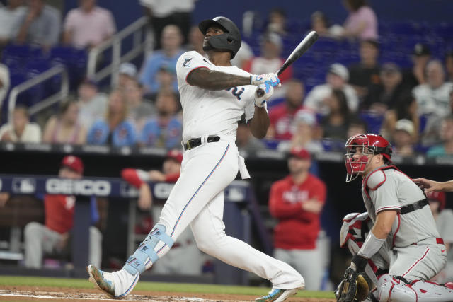 Miami Marlins' Jean Segura, left, is out at the plate on a throw from  Philadelphia Phillies second baseman Bryson Stott to catcher J.T. Realmuto,  right, during the eighth inning of a baseball