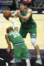 Dallas Mavericks forward Wes Iwundu, left, and center Boban Marjanovic, right, reach for a rebound during the second half of an NBA basketball game against the Los Angeles Clippers in Los Angeles Sunday, Dec. 27, 2020. (AP Photo/Kyusung Gong)