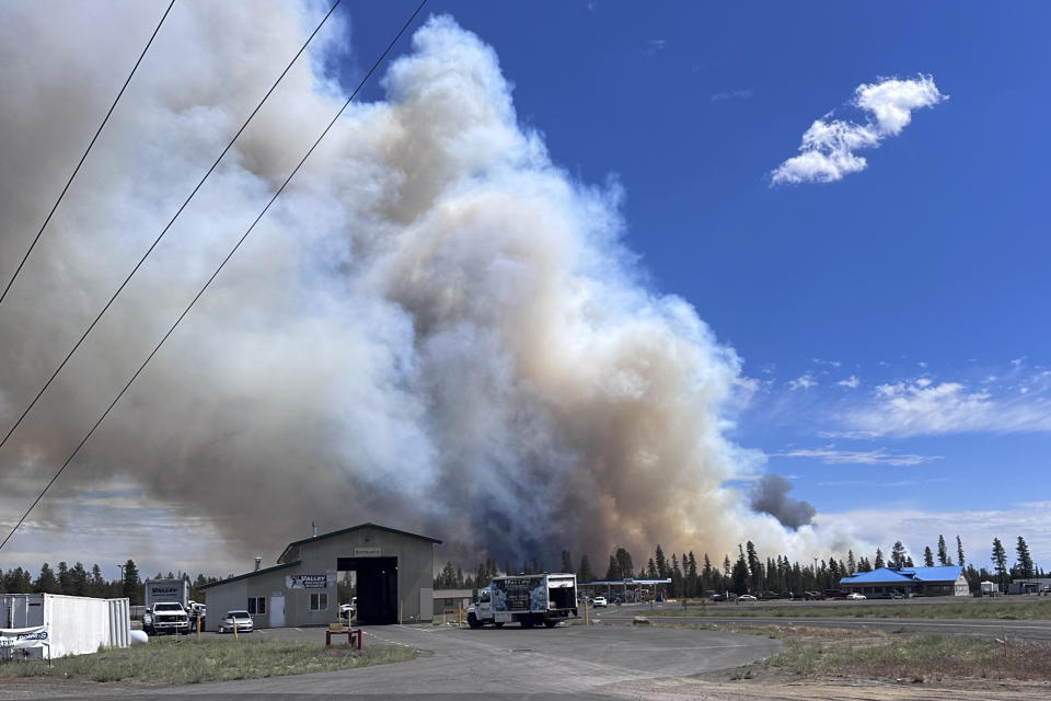 In this image provided by Jenny Braden, smoke rises from a wildfire on Tuesday, June 25, 2024, in La Pine, Ore. The wildfire near the popular vacation destination of Bend, is growing rapidly. Officials on Wednesday urged the continued evacuations of hundreds of homes in the area best known for its microbreweries, hiking, river rafting and skiing on nearby Mount Bachelor. (Jenny Braden via AP).