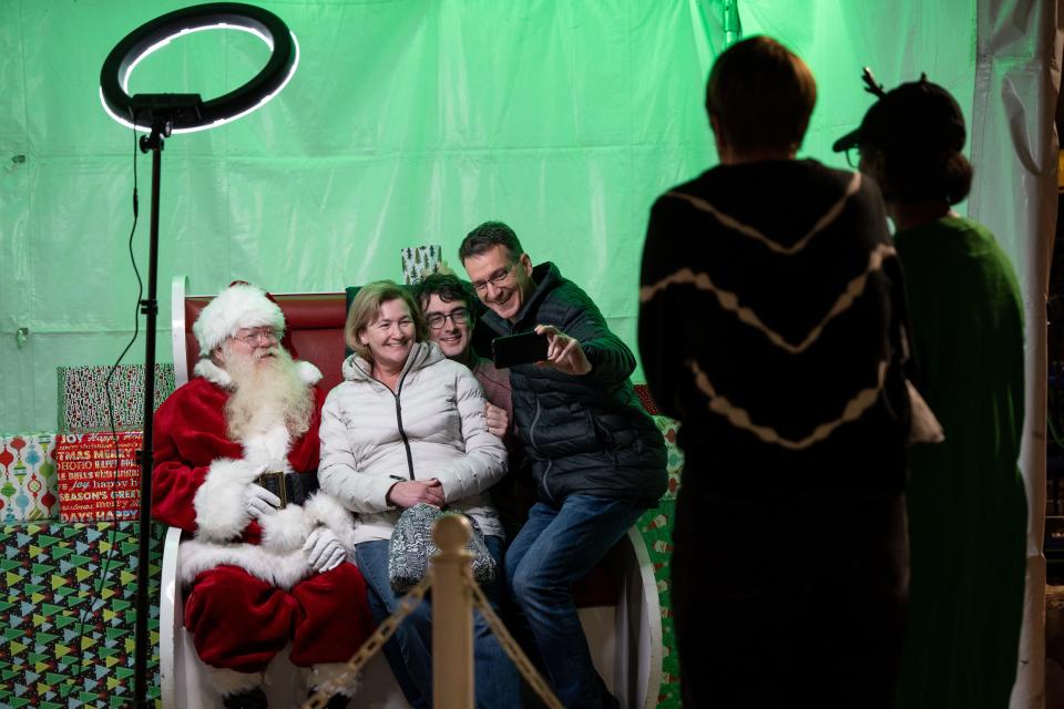 People take photos at the Fantasy of Lights Boat Parade at Tempe Beach Park on Dec. 10, 2022.