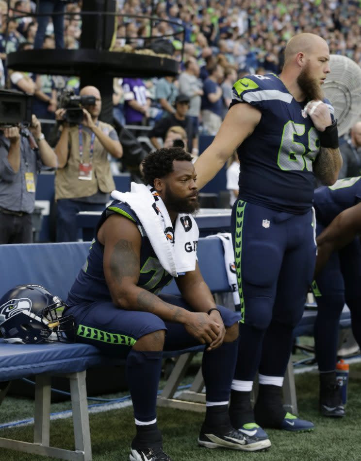 Eagles DE Michael Bennett sat toward the end of the national anthem in the 2018 NFL season opener. (AP)