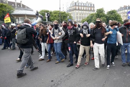 Masked youths take part in a demonstration in protest of the government's proposed labor law reforms in Paris, France, May 26, 2016. REUTERS/Charles Platiau