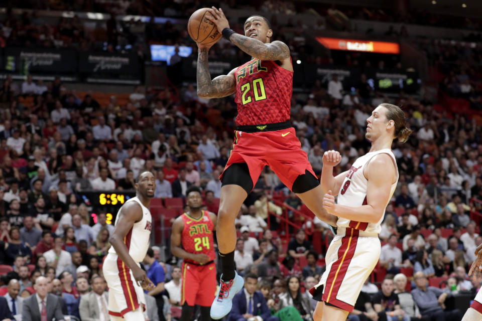 Atlanta Hawks forward John Collins (20) drives to the basket past Miami Heat forward Kelly Olynyk during the first half of an NBA basketball game Tuesday, Oct. 29, 2019, in Miami. (AP Photo/Lynne Sladky)
