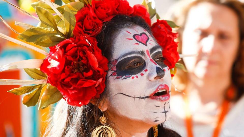 Claudia Olsen talks about Dia de los Muertos traditions during a Dia de los Muertos celebration on Saturday at Mission Plaza in San Luis Obispo.