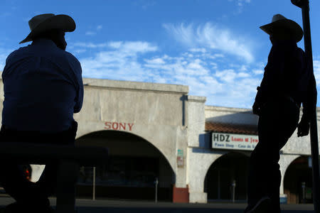 Men talk on a street in the town of Calexico, California, United States, October 8, 2016. REUTERS/Mike Blake