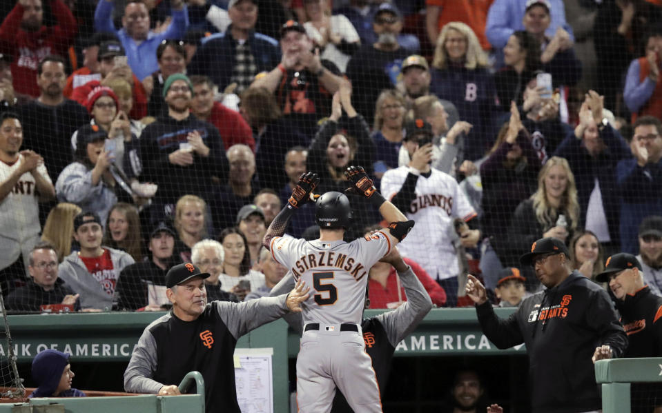San Francisco Giants' Mike Yastrzemski (5) is congratulated after his solo home run in the fourth inning of a baseball game against the Boston Red Sox at Fenway Park in Boston, Tuesday, Sept. 17, 2019. Yastrzemski is the grandson of Red Sox great and Hall of Famer Carl Yastrzemski. (AP Photo/Charles Krupa)