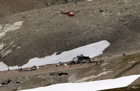 A helicopter is seen above the accident site of a Junkers Ju-52 airplane of the local airline JU-AIR that is 2,450 meters (8,038 feet) above sea level near the mountain resort of Flims, Switzerland August 5, 2018. REUTERS/Arnd Wiegmann