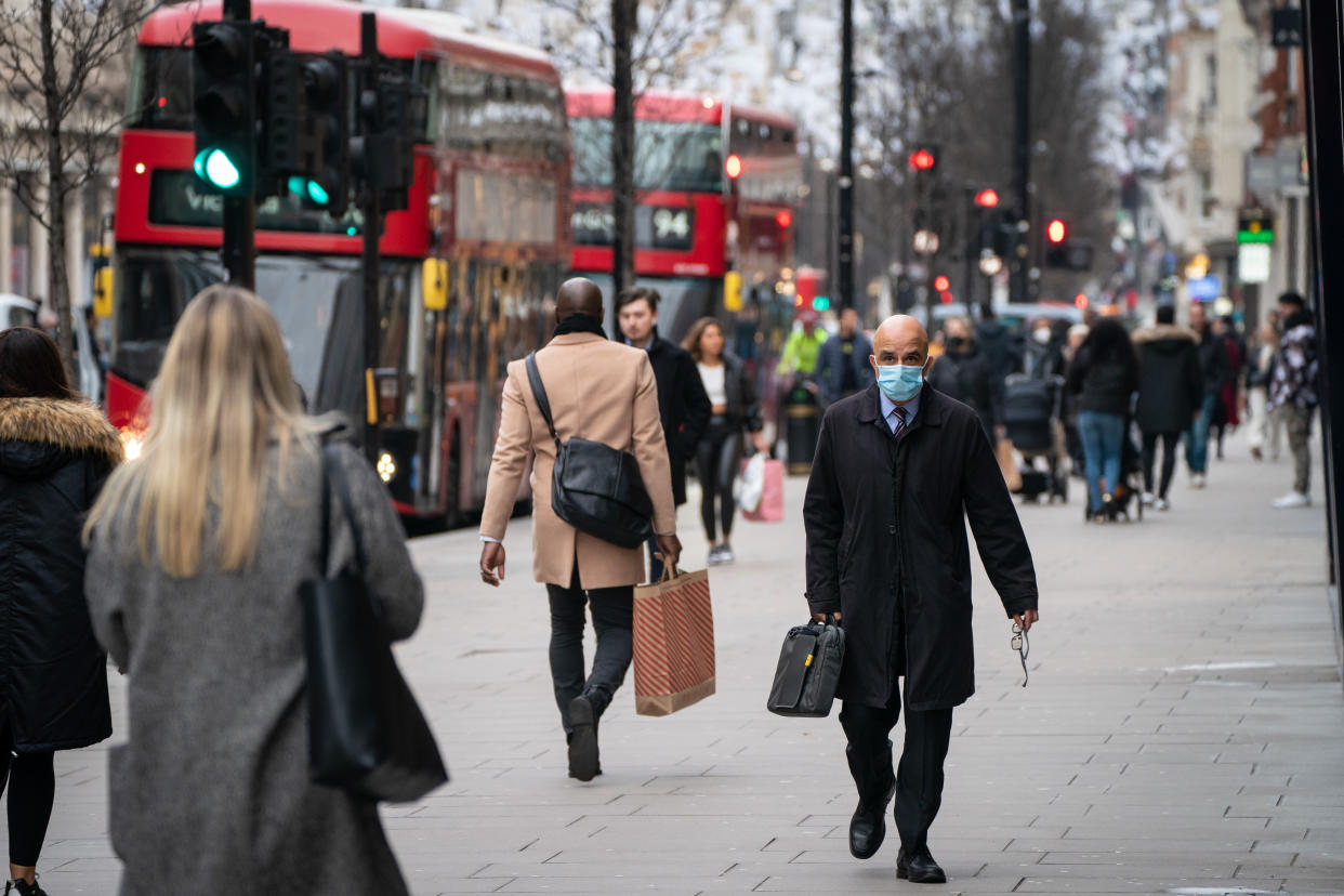 People wearing face masks on Oxford Street, in central London. Picture date: Monday January 10, 2022.