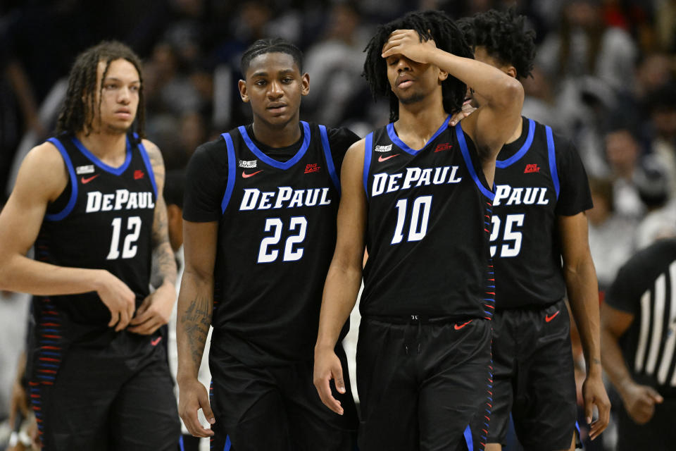 DePaul guard Elijah Fisher (22) comforts teammate Jaden Henley (10) in the second half of an NCAA college basketball game against UConn, Tuesday, Jan. 2, 2024, in Storrs, Conn. (AP Photo/Jessica Hill)