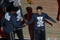 Atlanta Hawks guard Trae Young (11) is introduced while wearing a shirt commemorating MLK Day prior to an NBA basketball game against the Minnesota Timberwolves on Monday, Jan. 18, 2021, in Atlanta. (AP Photo/Todd Kirkland)