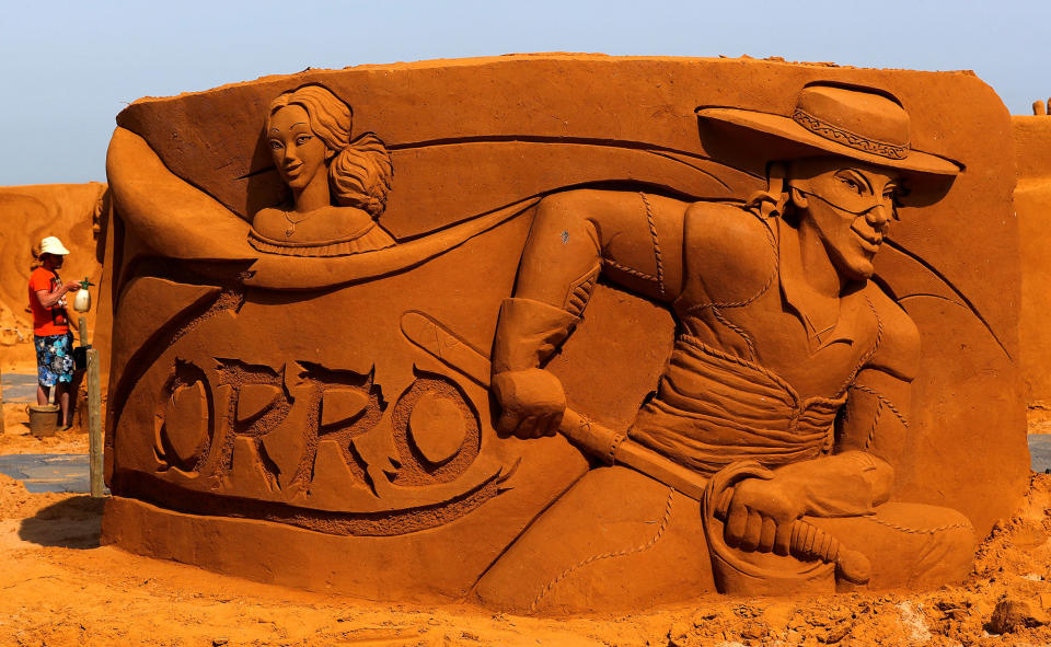 <p>An artist works on a sculpture during the Sand Sculpture Festival “Disney Sand Magic” in Ostend, Belgium June 22, 2017. (Yves Herman/Reuters) </p>