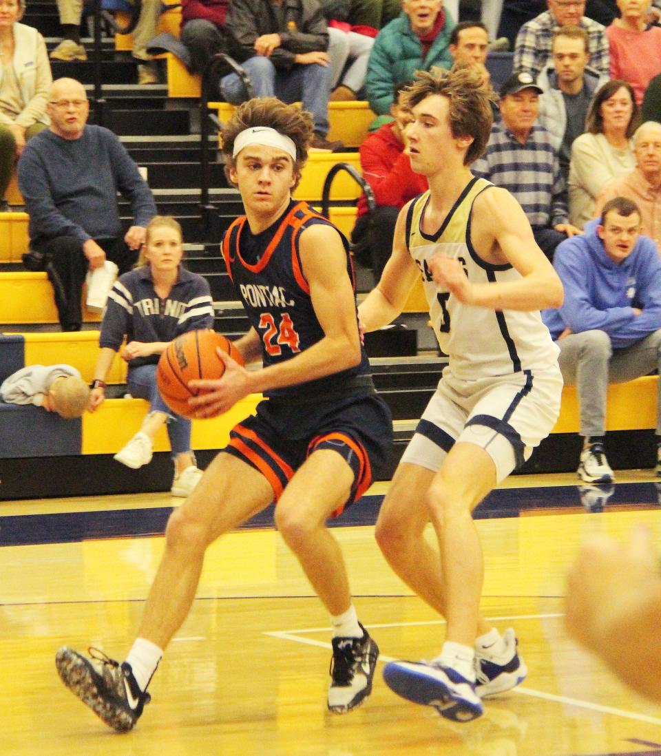 Kerr Bauman of Pontiac pulls up as Central Catholic's Cole Certa defends Friday. Bauman scored 17 points to help lead the Indians to a 73-65 victory.