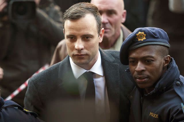 Chris Jude/Anadolu Agency/Getty Images Oscar Pistorius arrives with security at the North Gauteng High Court to attend summary judgement on his trial on July 6, 2016 in Pretoria, South Africa.