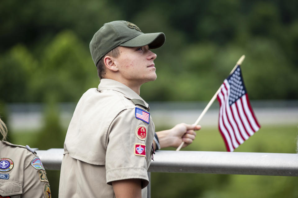 Area residents arrive to show their respect before the funeral procession for Medal of Honor recipient Hershel "Woody" Williams passes by on Saturday, July 2, 2022, in Teays Valley, W.Va. (Sholten Singer/The Herald-Dispatch via AP)