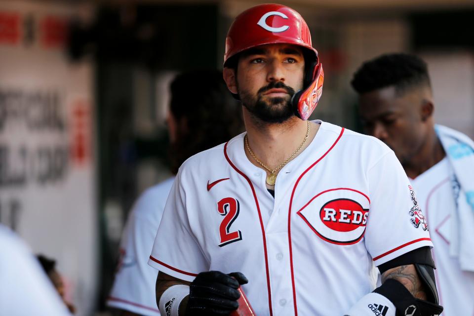 Cincinnati Reds right fielder Nick Castellanos (2) walks through the dugout after hitting a sacrifice fly to score Jonathan India in the fourth inning of the MLB National League game between the Cincinnati Reds and the Pittsburgh Pirates at Great American Ball Park in downtown Cincinnati on Monday, Sept. 27, 2021. The Reds led 8-1 in the top of the sixth inning. 