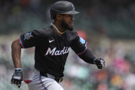 Miami Marlins' Bryan De La Cruz (14) runs out a ground ball against the Detroit Tigers in the third inning of a baseball game, Wednesday, May 15, 2024, in Detroit. (AP Photo/Paul Sancya)