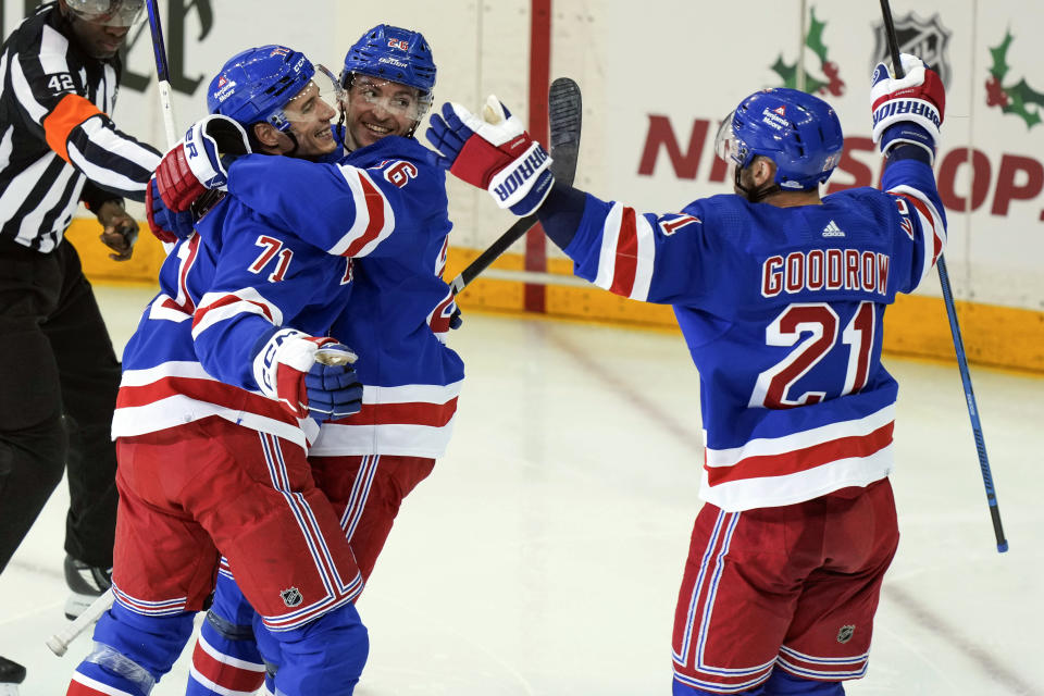 New York Rangers Tyler Pitlick (71) celebrates with Jimmy Vesey (26) and Barclay Goodrow (21) following his goal during the third period an NHL hockey game against the Boston Bruins, Saturday, Nov. 25, 2023, in New York. (AP Photo/Bryan Woolston)