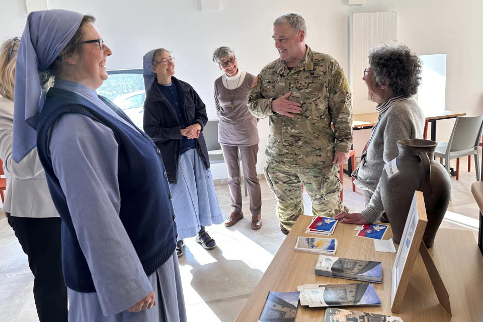 Joint Chiefs Chairman Gen. Mark Milley shares stories of his own Catholic upbringing with nuns who run "Grange de la Paix," a modern peace institute in Sainte-Mere-Eglise, Normandy, France on June 4, 2023. The peace institute has a beautiful wooden cone-shaped inner sanctuary that requires total silence. The talkative Milley joked about how long he might last in there. Milley was on his last visit to Normandy as a soldier and spent a lot of time soaking in the conversations with soldiers, veterans and townspeople. (AP Photo/Tara Copp)