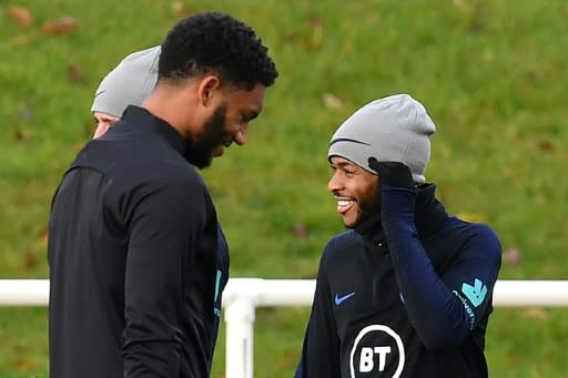 Defender Joe Gomez (left) and forward Raheem Sterling attend an England team training session on November 12, 2019