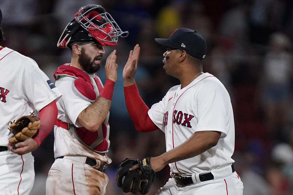 Boston Red Sox's Connor Wong, left, celebrates with Rafael Devers, right, after the Red Sox beat the New York Mets 6-1 in a baseball game, Sunday, July 23, 2023, in Boston. (AP Photo/Steven Senne)