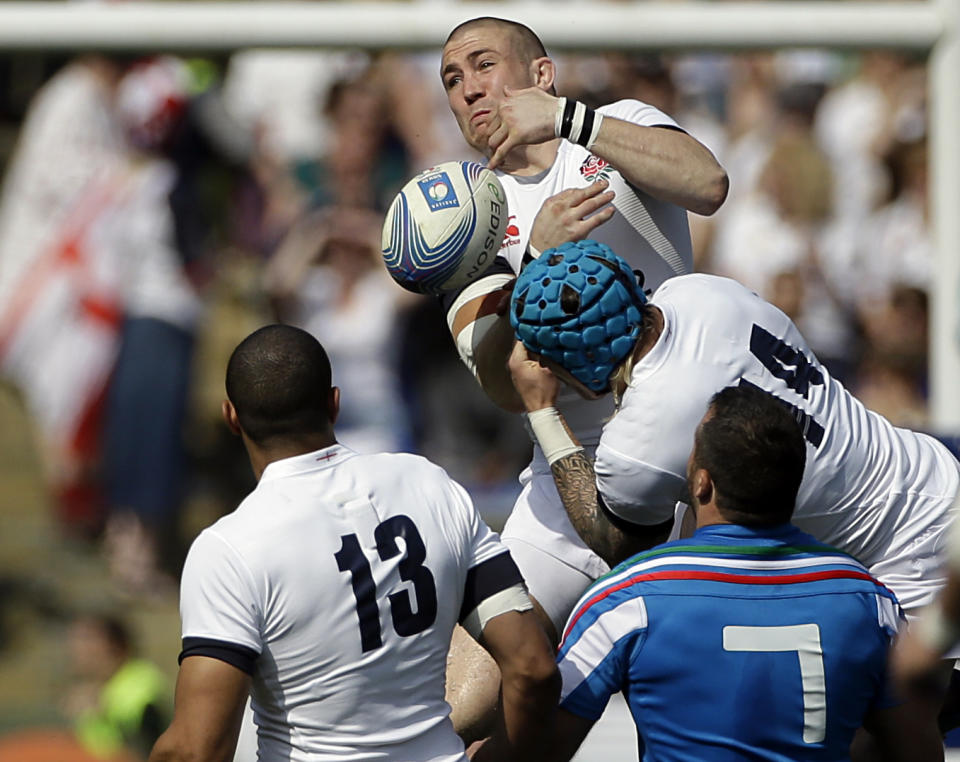 England's Mike Brown, top, collides with teammate Jack Nowell as he tries to catch the ball during the Six Nations Rugby Union match between Italy and England at Rome's Olympic stadium, Saturday, March 15, 2014. (AP Photo/Gregorio Borgia)