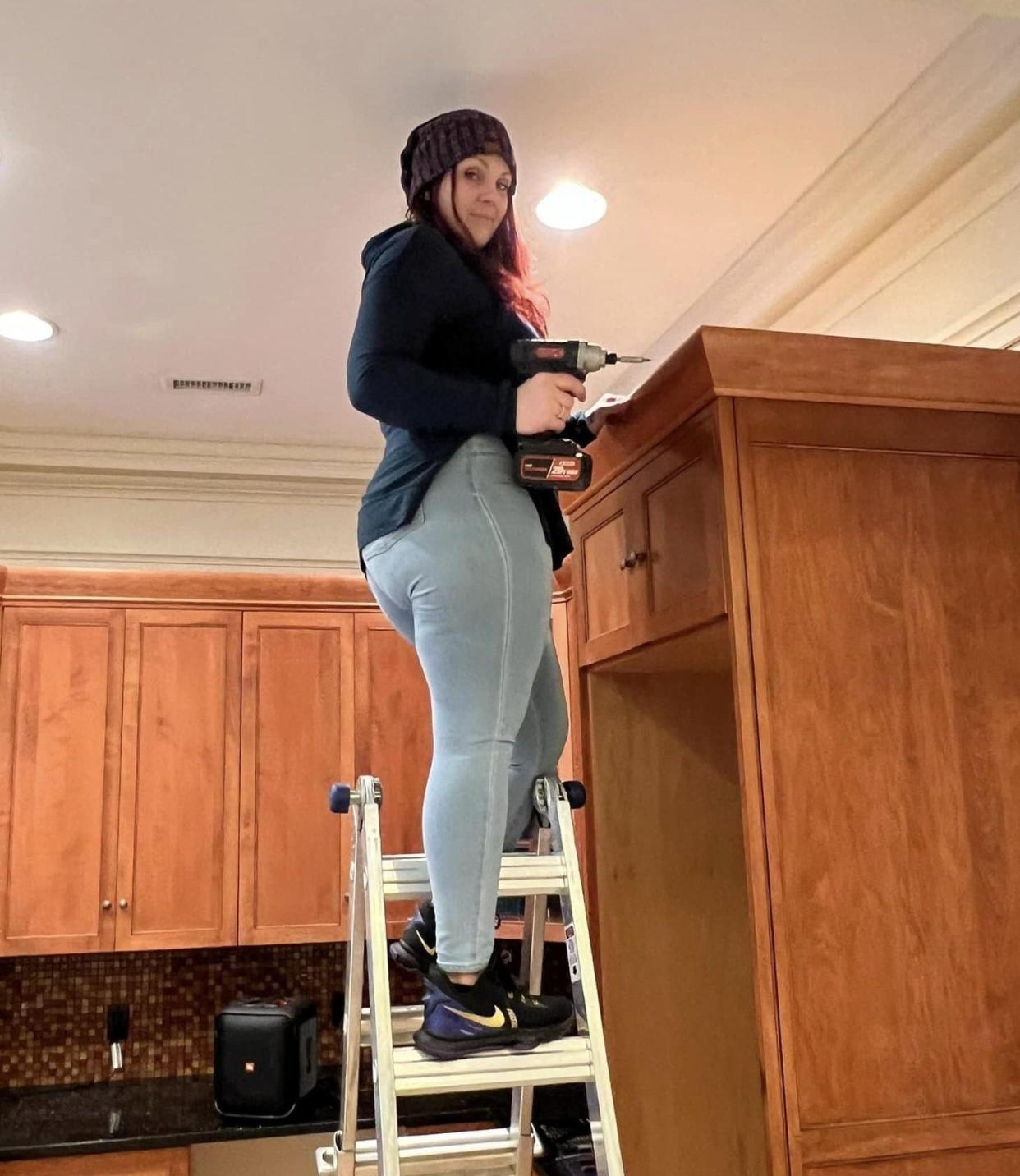 Tara Sample, Thisability CEO and founder, gets ready to remove a cabinet at the nonprofit organization's new home office at 135 W. Tabb St. in Petersburg.