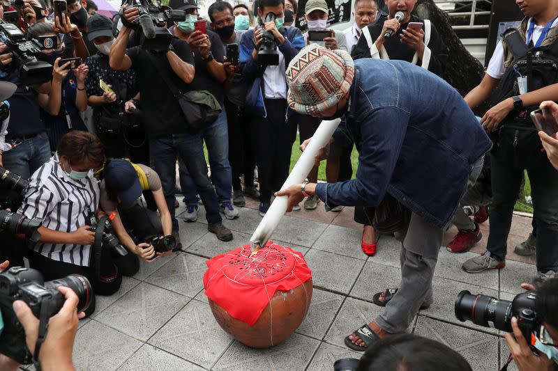 Pro-democracy protesters perform a ritual to capture the spirits of the Royal Thai Army leaders at the Royal Thai Army Headquarters in Bangkok