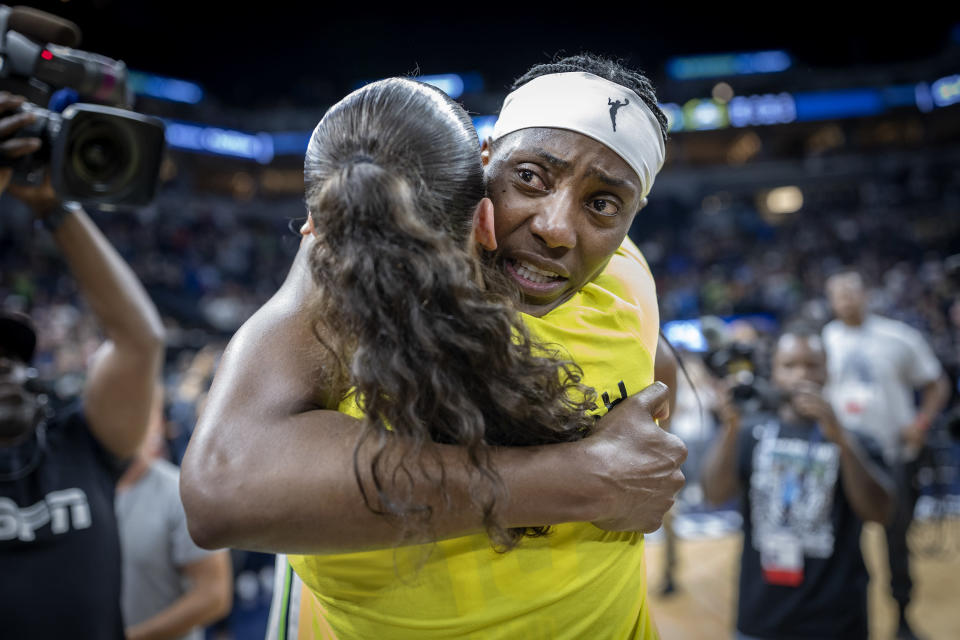Minnesota Lynx center Sylvia Fowler, rear, hugs Seattle Storm guard Sue Bird (10) after a WNBA basketball game Friday, Aug. 12, 2022, in Minneapolis. (Elizabeth Flores/Star Tribune via AP)