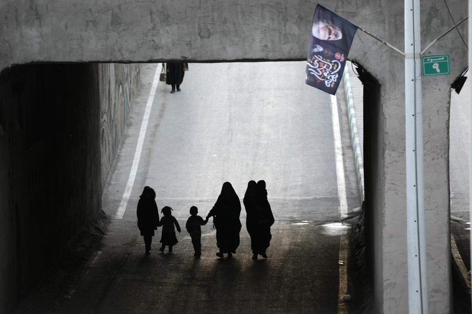 People walk towards the grave of the late Iranian Revolutionary Guard Gen. Qassem Soleimani in the city of Kerman about 510 miles (820 kms) southeast of the capital Tehran, Iran, Thursday, Jan. 4, 2024. Investigators believe suicide bombers likely carried out an attack on a commemoration for an Iranian general slain in a 2020 U.S. drone strike, state media reported Thursday, as Iran grappled with its worst mass-casualty attack in decades and as the wider Mideast remains on edge. (AP Photo/Vahid Salemi)