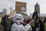 Hospitality workers protest in Parliament Square in London, Monday, Oct. 19, 2020. Hospitality workers are demonstrating outside Parliament against tougher coronavirus restrictions and the amount of financial support given by the government to the industry.(AP Photo/Frank Augstein)