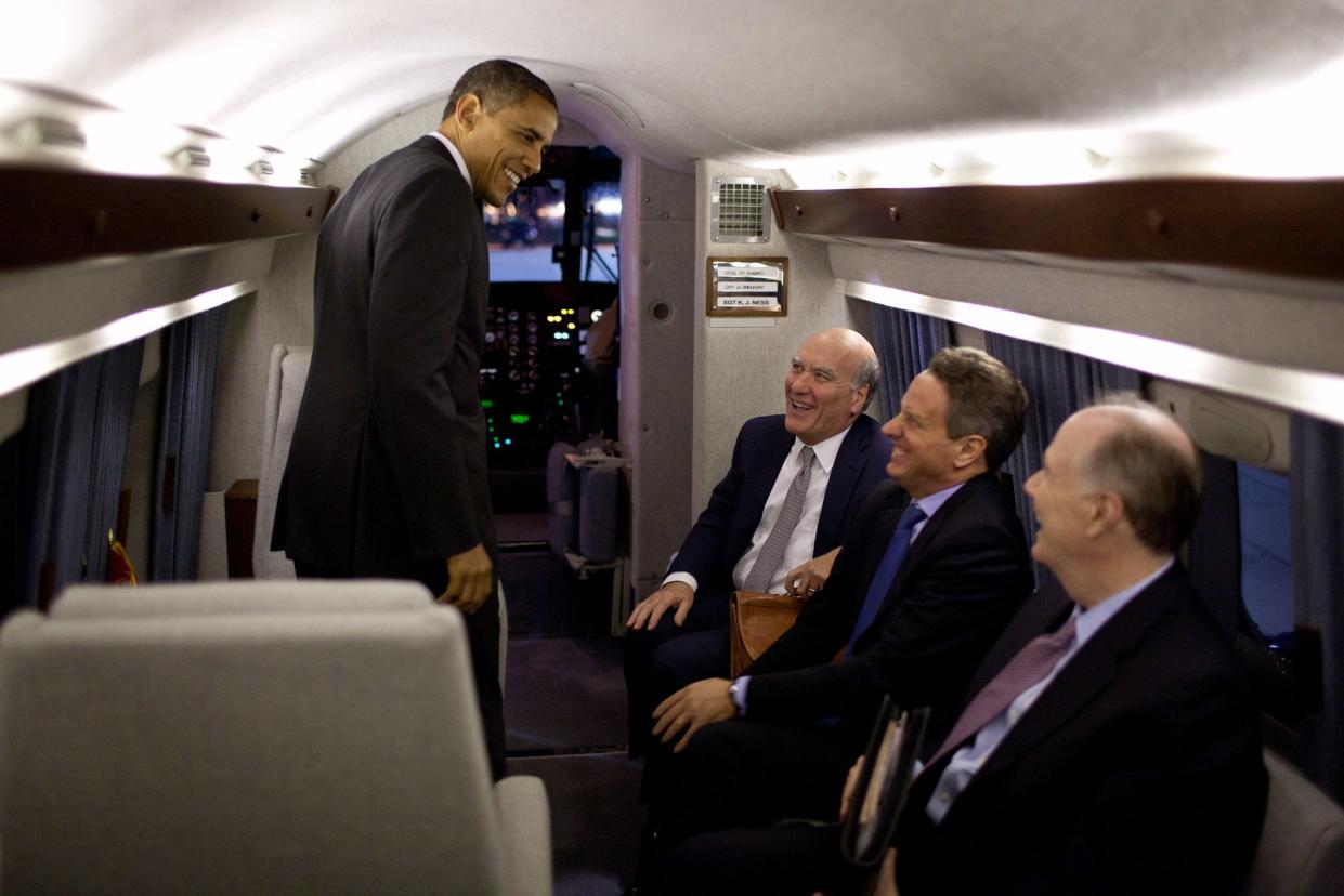 President Barack Obama talks with Chief of Staff Bill Daley, Treasury Secretary Timothy Geithner, and National Security Advisor Tom Donilon aboard Marine One