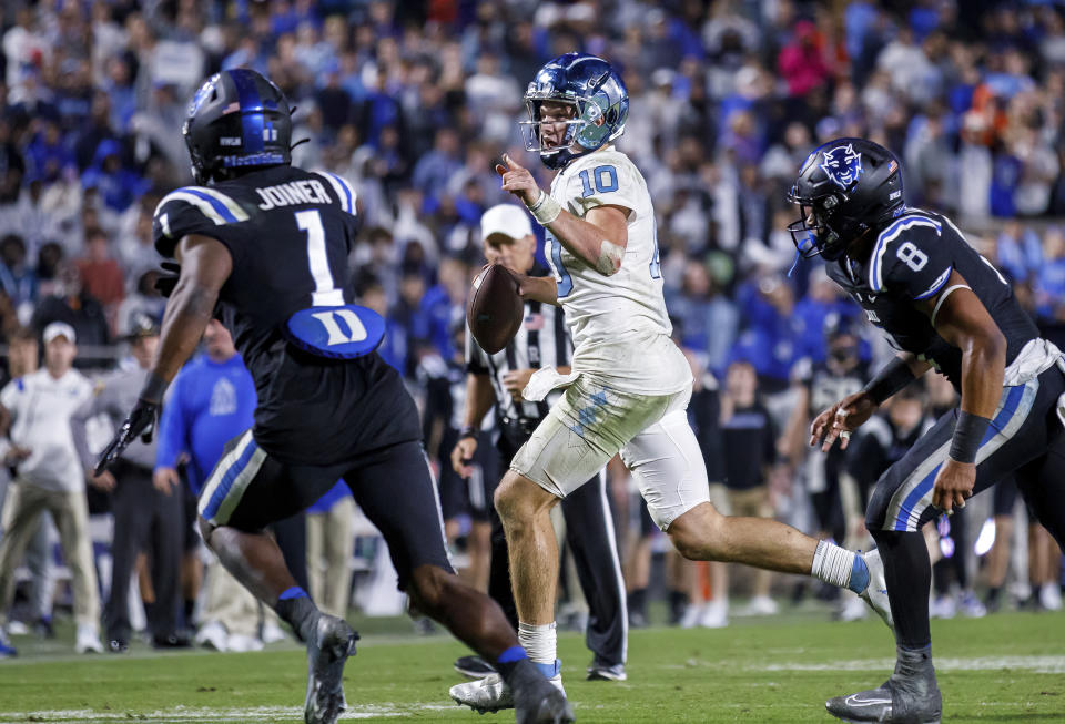 North Carolina's Drake Maye (10) scrambles out of the pocket before throwing the game-winning touchdown pass during the second half of an NCAA college football game against Duke in Durham, N.C., Saturday, Oct. 15, 2022. (AP Photo/Ben McKeown)