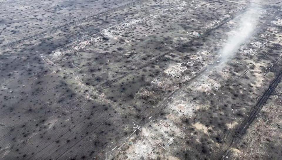 In this screen grab from a video taken on Wednesday, Dec. 6, 2023 by the BUAR done unit of the 110th Mechanized Brigade, an ariel view on the ground covered with craters from artillery shell explosions in a destroyed village of Stepove, near Avdiivka, Ukraine. About 150 bodies can be seen in two separate video clips filmed over treelines to the north and south of Stepove. (Ukrainian 110th mechanized brigade via AP)