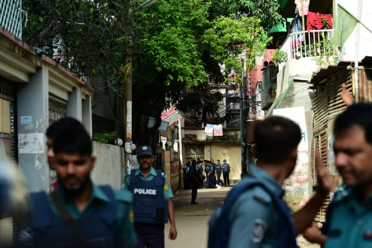 Bangladeshi police stand guard in front of the house where police killed nine suspected Islamist extremists in Dhaka on July 26, 2016