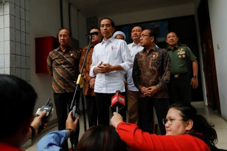 Indonesia's President Joko Widodo gestures as he talks during a news conference at Gatot Subroto military hospital in Jakarta