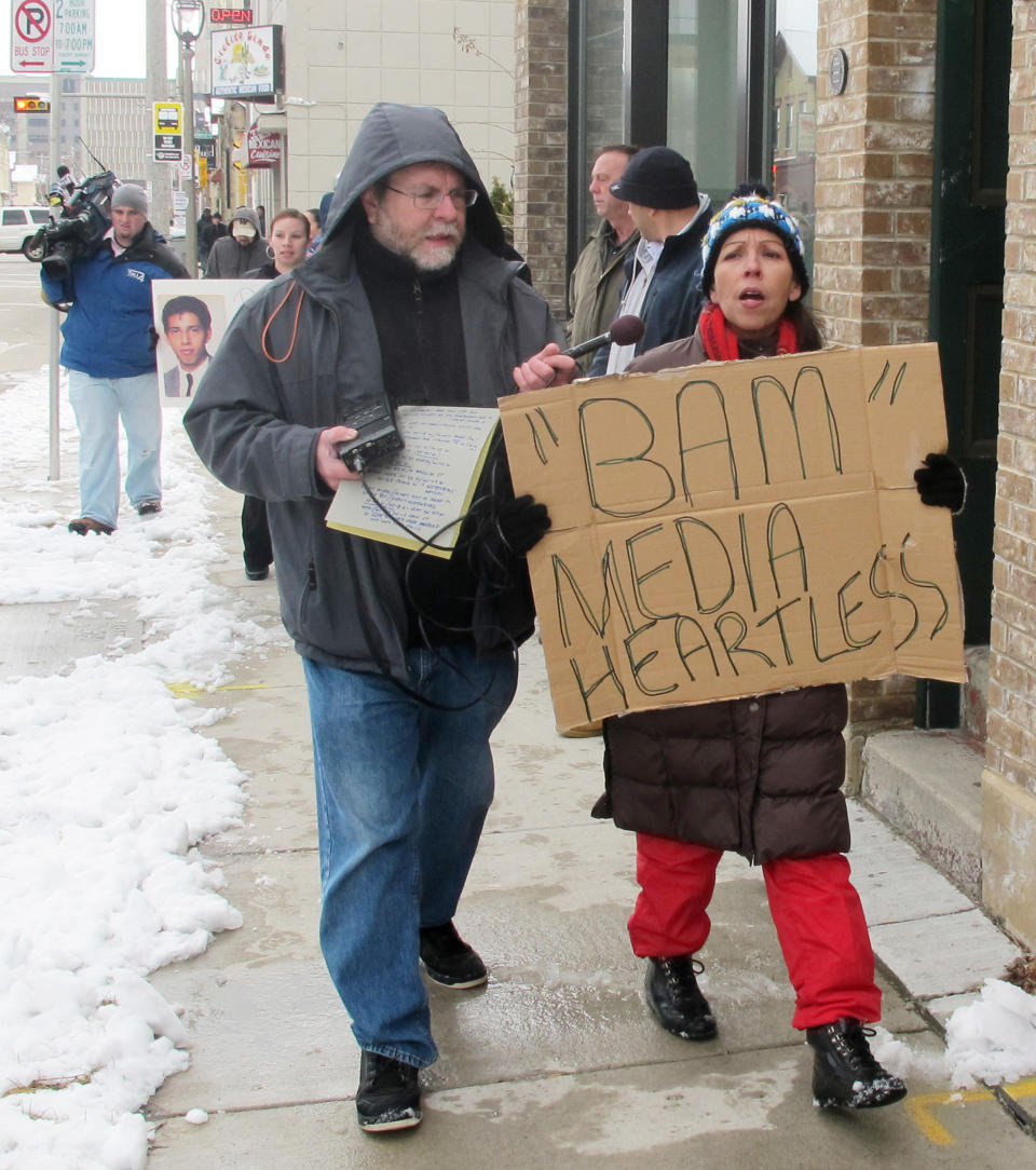 In this March 3, 2012 photo, Janie Hagen, right, protests in Milwaukee against Bam Marketing and Media, which is organizing a walking tour of bars where serial killer Jeffrey Dahmer hunted his victims. Hagen's brother, 25-year-old Richard Guerrero, disappeared in 1988 and was one of the first young men Dahmer is known to have murdered. (AP Photo/Dinesh Ramde)