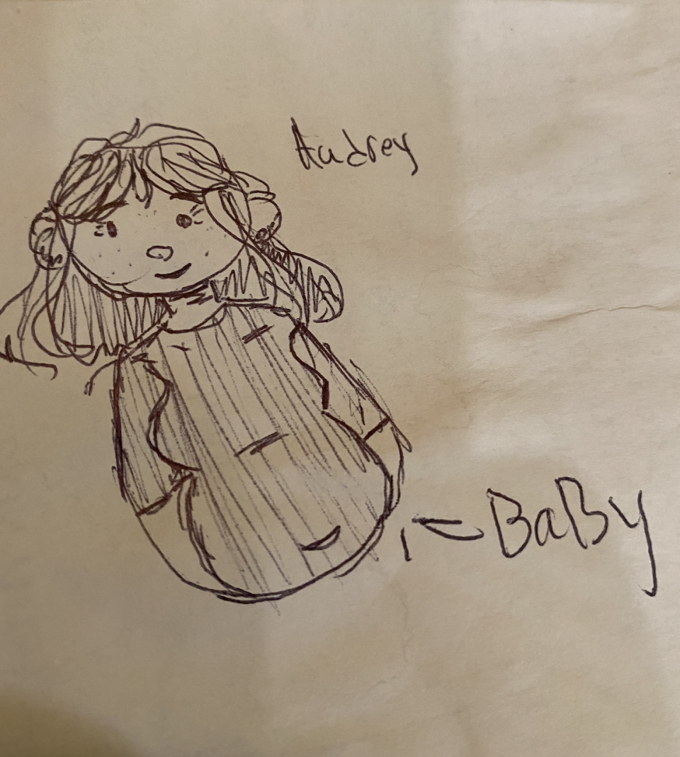 a drawing of Audrey with an arrow pointing to her belly and the word "baby"