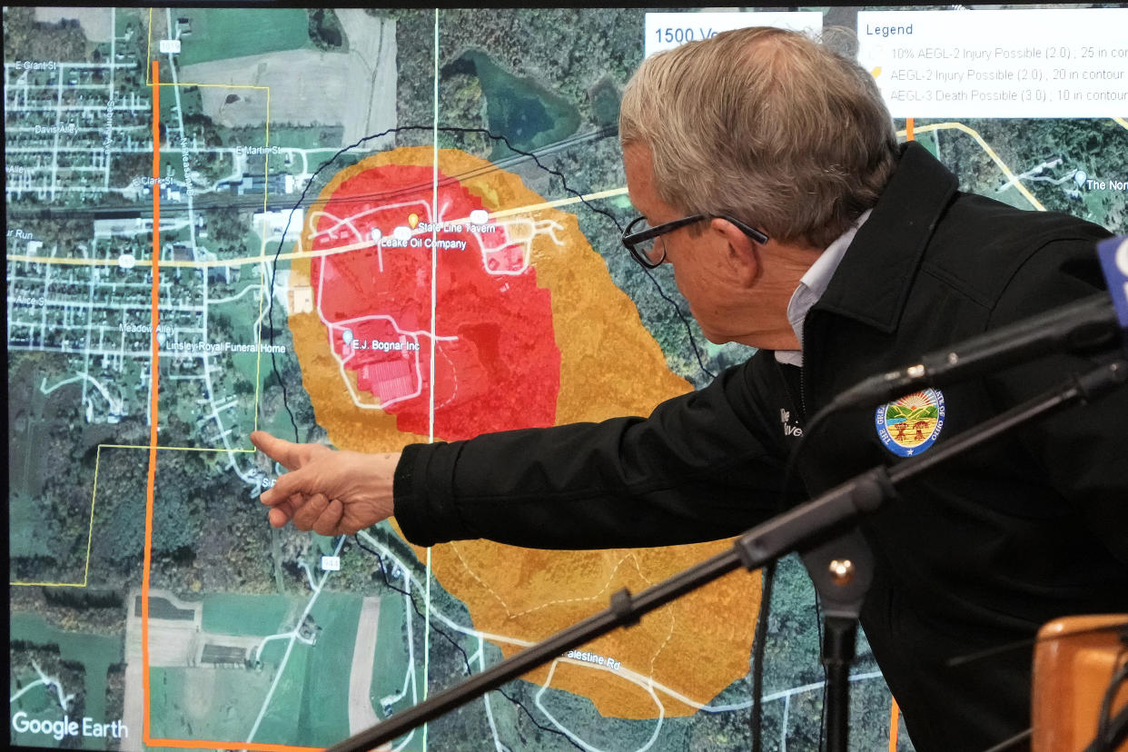 FILE - Ohio Gov. Mike DeWine points to a map of East Palestine, Ohio that indicates the area that has been evacuated as a result of Norfolk Southern train derailment, after touring the site, Feb. 6, 2023, in East Palestine, Ohio. After toxic chemicals were released into the air from a wrecked train in Ohio, evacuated residents remain in the dark about what toxic substances are lingering in their vacated neighborhoods while they await approval to return home. (AP Photo/Gene J. Puskar)