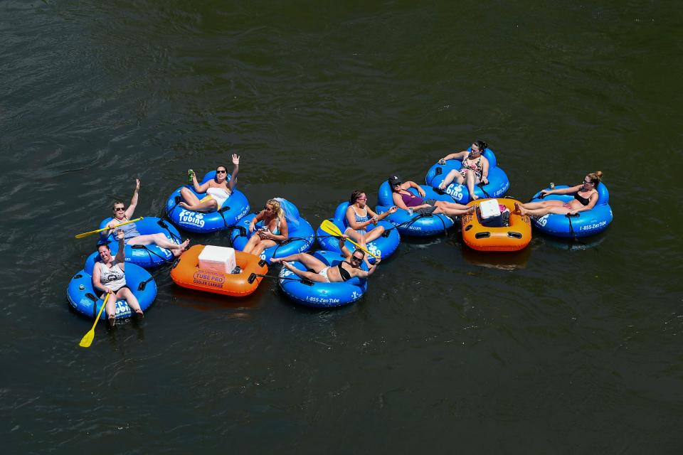 People cool off by floating down the French Broad River.