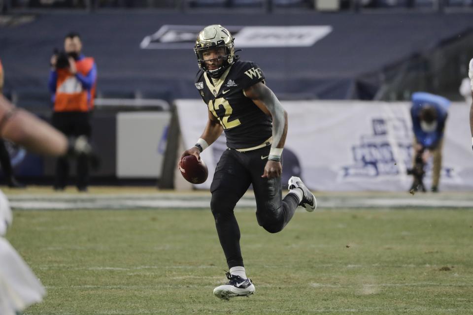 Wake Forest's Jamie Newman (12) rushes during the first half of the Pinstripe Bowl NCAA college football game against Michigan State, Friday, Dec. 27, 2019, in New York. (AP Photo/Frank Franklin II)