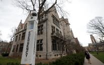 A woman walks through the Main Quadrangle at the University of Chicago in Chicago, Illinois, United States, November 30, 2015. The University canceled Monday classes and activities after being warned by the FBI that someone had made an online threat of gun violence on campus, university President Robert J. Zimmer announced on Sunday. (REUTERS/Jim Young)