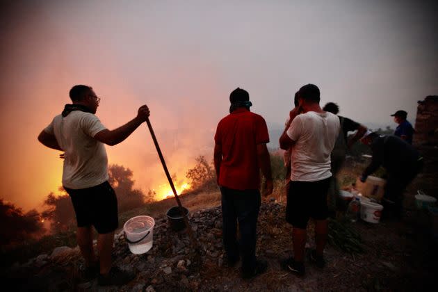 Fire crews, helped by inhabitants, work to put out a fire spreading in the Aegean coast city of Oren, near Milas, in the holiday region of Mugla on August 3, 2021 (Photo: STR via Getty Images)