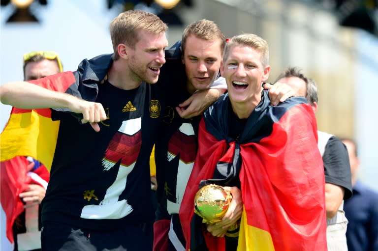 Bastian Schweinsteiger (right) and teammates celebrate their FIFA World Cup 2014 title at a victory parade in Berlin in July 2014